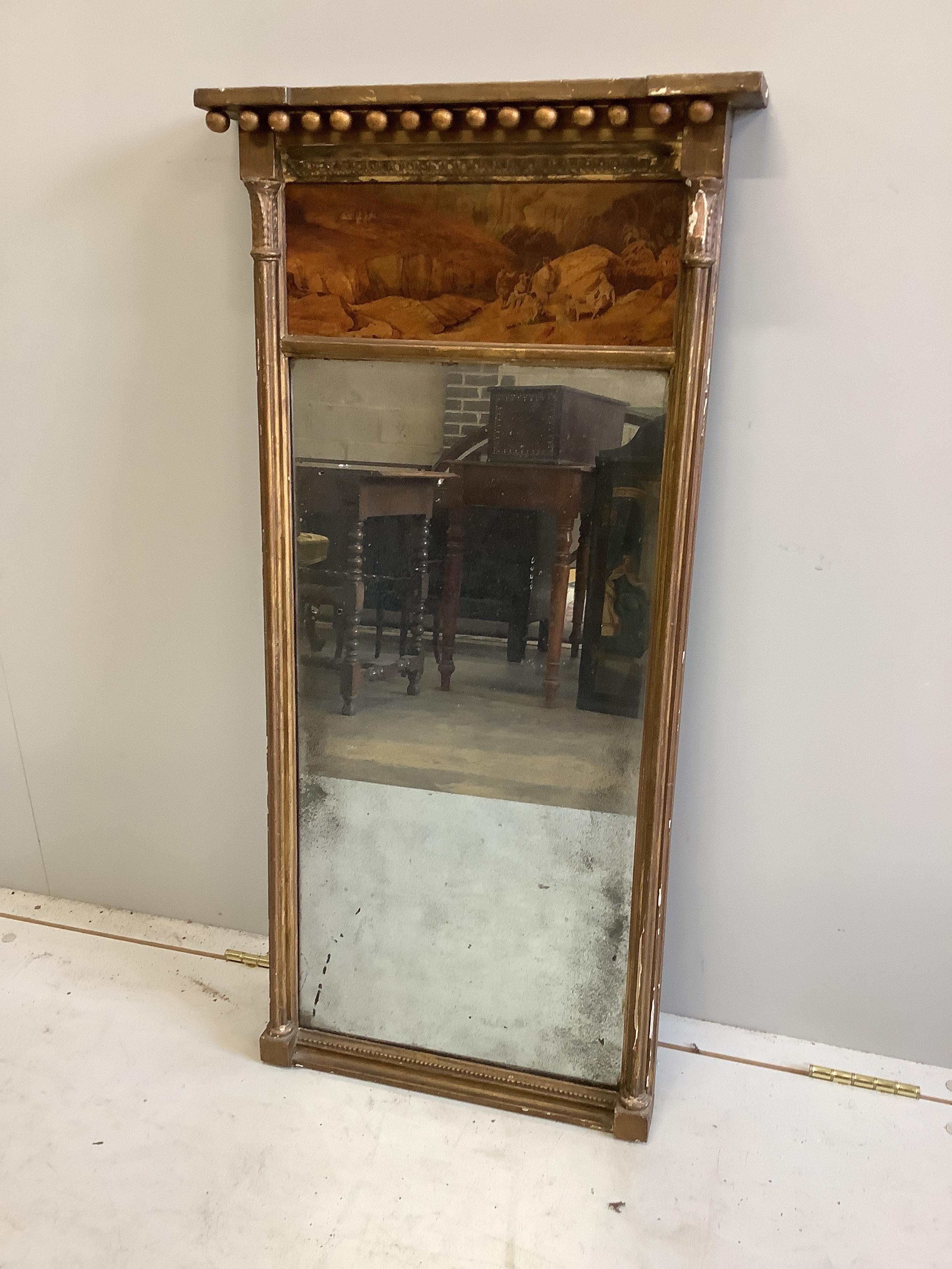 A Regency giltwood and composition pier glass with painted landscape tablet, width 46cm, height 94cm